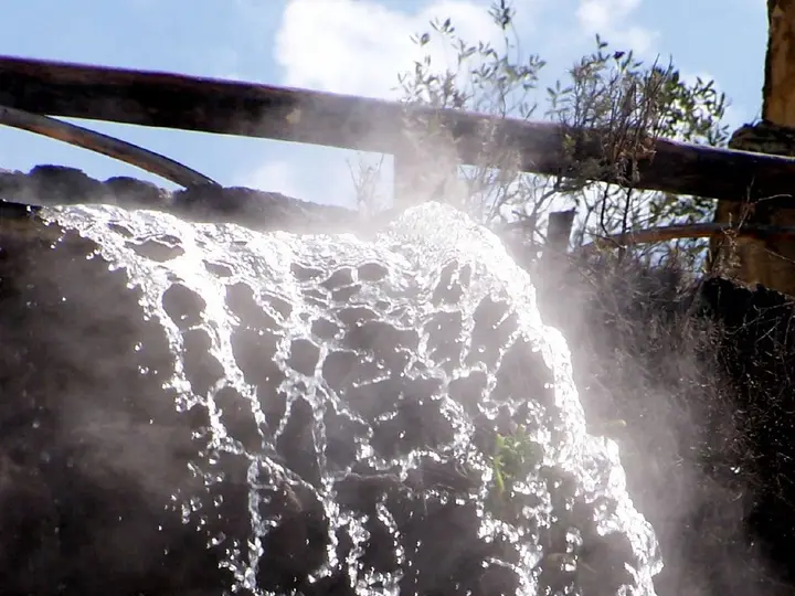 Steaming hot water cascading down a rock wall at Giardini Poseidon Terme on Ischia