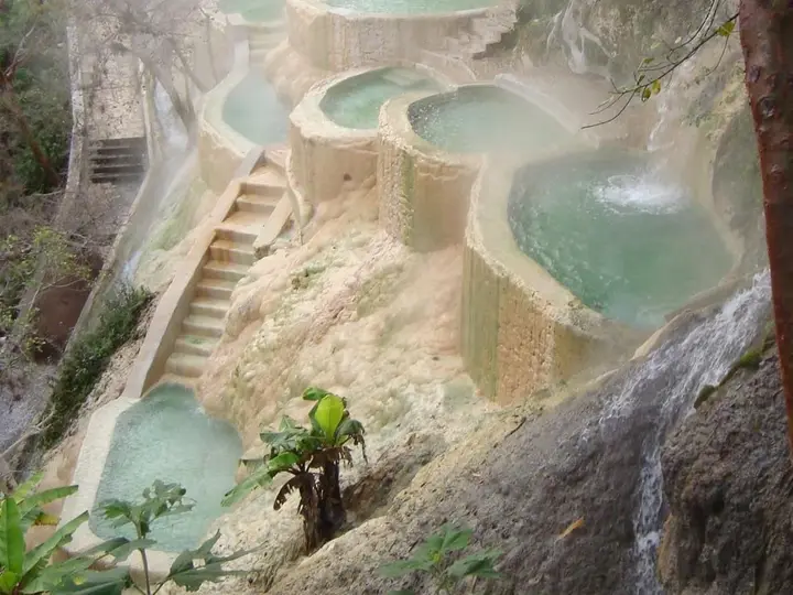 Steaming terraced turquoise pools stepping down a cliffside at Grutas Tolantongo in Hidalgo