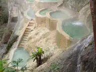 Steaming terraced turquoise pools stepping down a cliffside at Grutas Tolantongo in Hidalgo