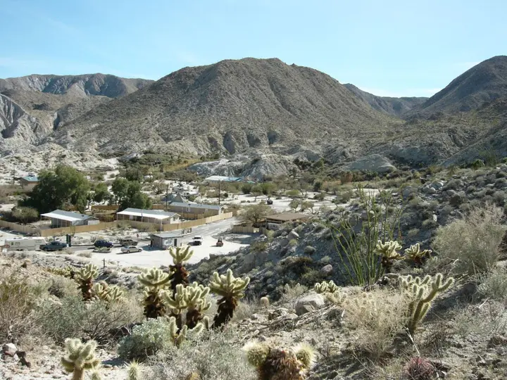Agua Caliente County Park campground and buildings among cholla cactus below rocky desert hills