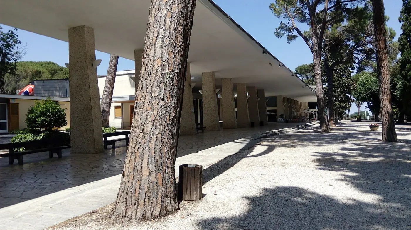 Long shaded colonnade among pine trees in the Acqua Santa spa park, Chianciano Terme