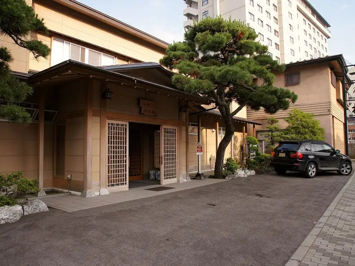 Traditional ryokan entrance with a pine tree in Hakodate Yunokawa Onsen