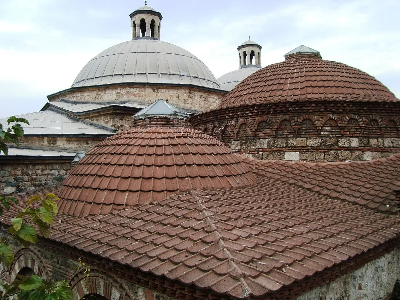 Tiled domes and lantern roofs of the Eski Kaplıca Ottoman bathhouse in Çekirge, Bursa