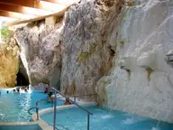 Turquoise thermal pool inside the limestone cave at Miskolctapolca with water spouting from rock