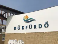Entrance building of Bükfürdő Thermal and Spa with the Bükfürdő logo and large letter sign