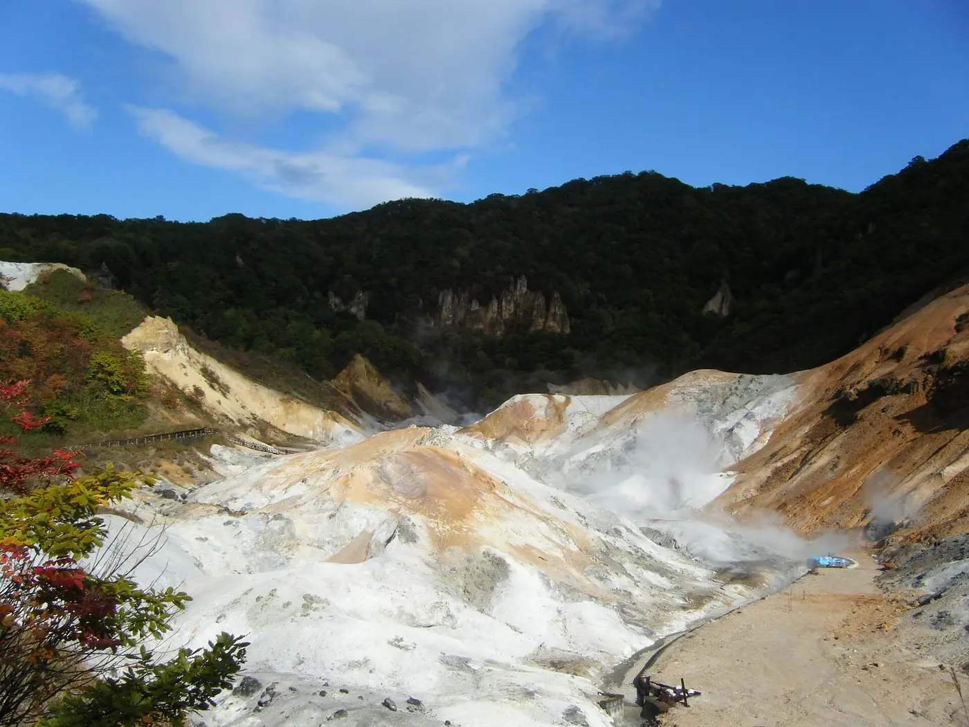 Steaming white and orange volcanic slopes of Jigokudani, the source of Noboribetsu Onsen