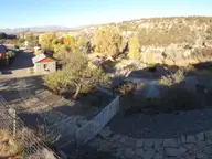 Stone cabins and autumn cottonwoods at Chinati Hot Springs in a desert canyon near Ruidosa
