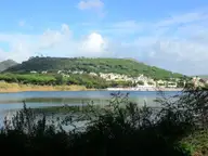 Lake Lucrino with the green cone of Monte Nuovo behind, below the Stufe di Nerone hillside