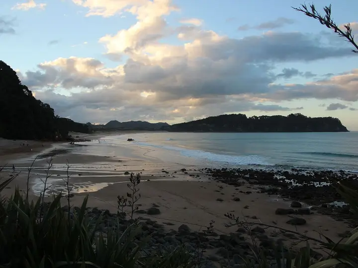 Sunset light over Hot Water Beach looking north past the rocky bluff where the hot water rises