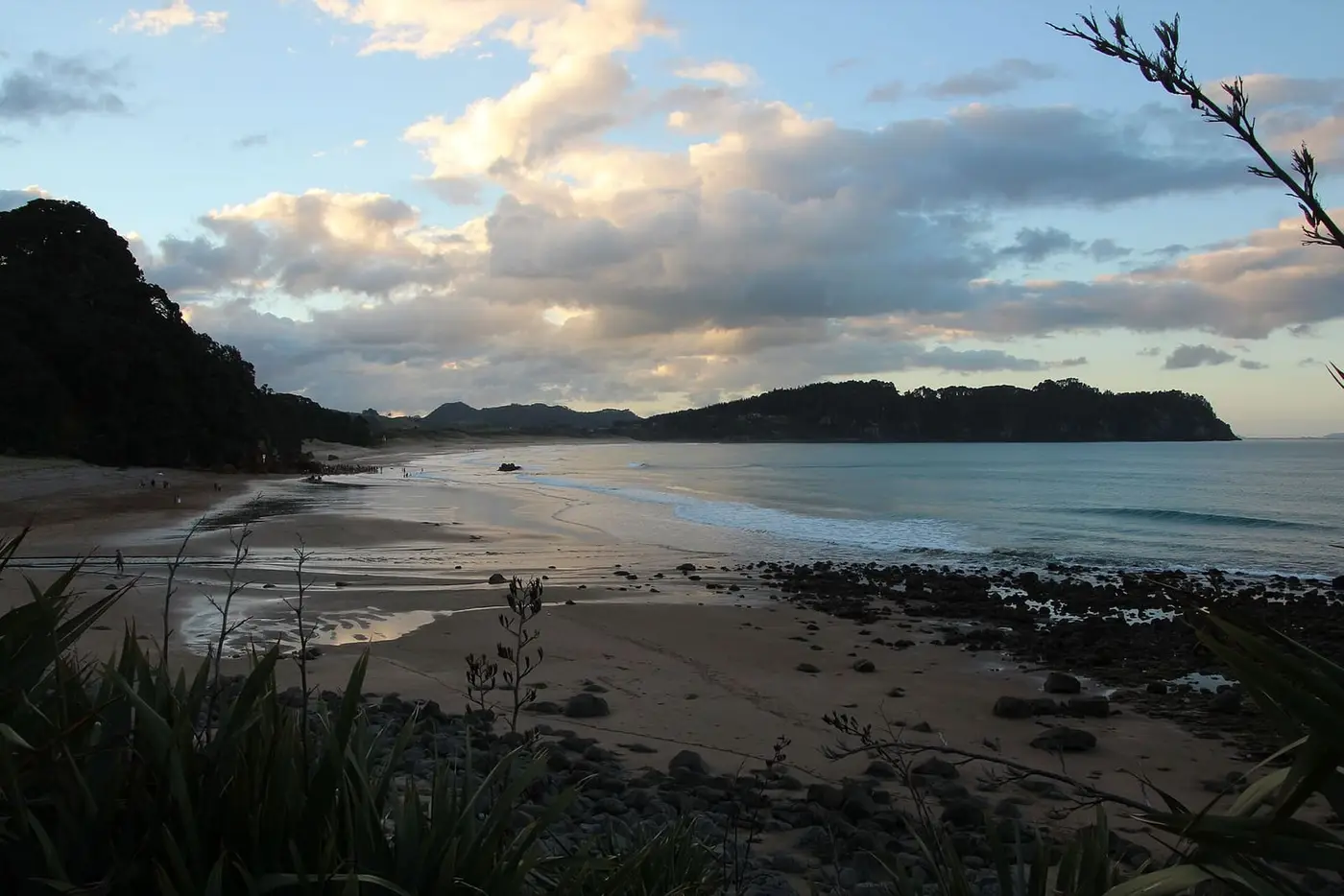 Sunset light over Hot Water Beach looking north past the rocky bluff where the hot water rises